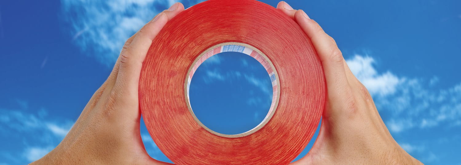 Row of cosmetic foundation or skincare bottles in varying shades, arranged side by side against a neutral background to showcase a broad range of skin tones.